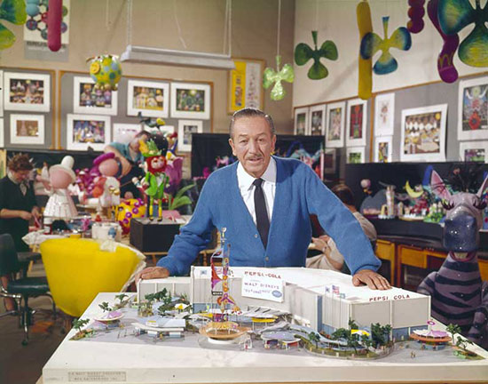 Walt Disney with mock up plans for It's a Small World